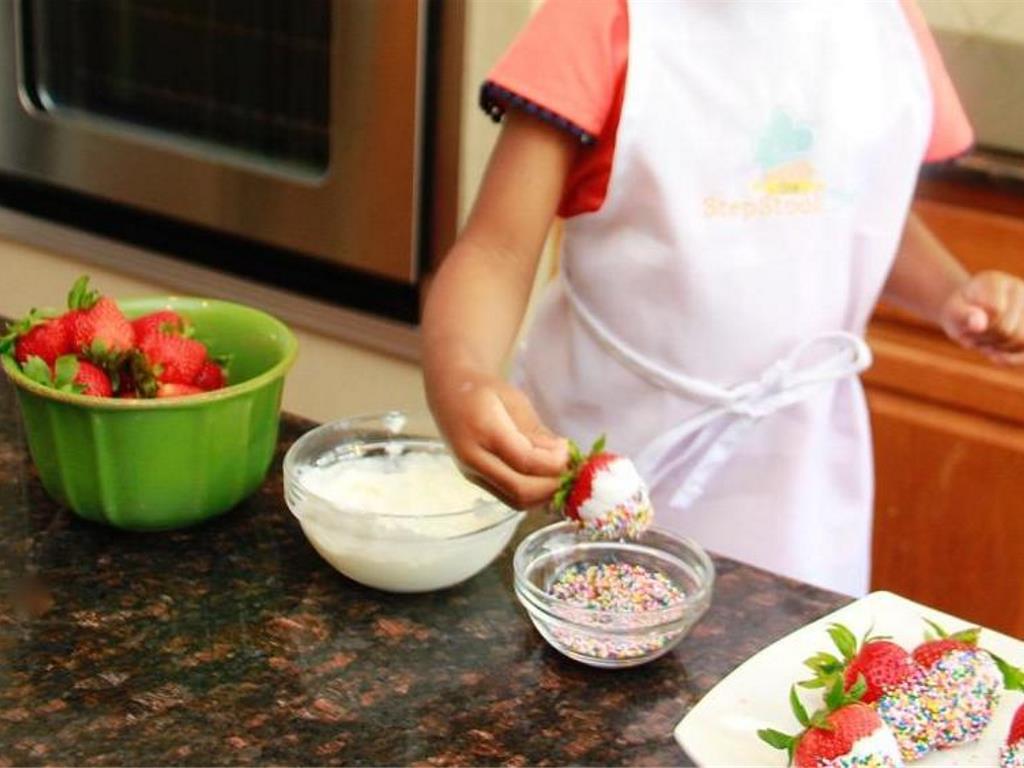 Step 3 of Confetti Dipped Strawberries Recipe: Dip the yogurt covered strawberry in small bowl of Sprinkles (1/3 cup).