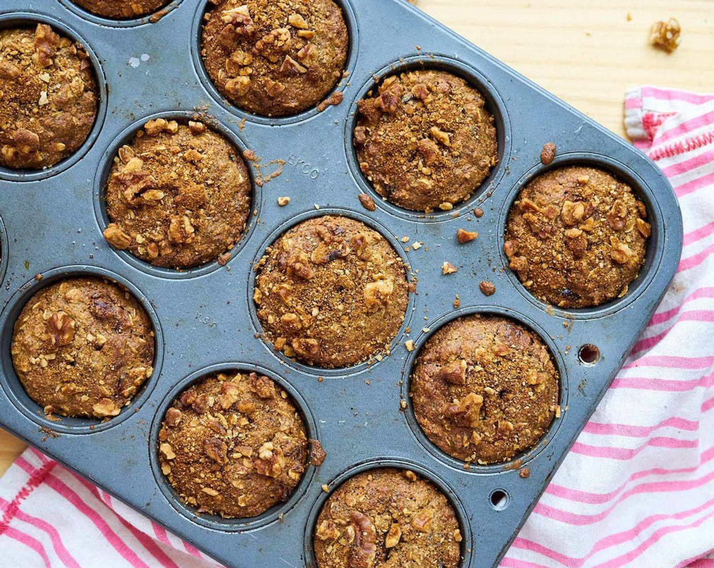 step 8 Pour the batter into 12 muffin tins. Evenly divide walnut coconut sugar topping between 12 muffins.