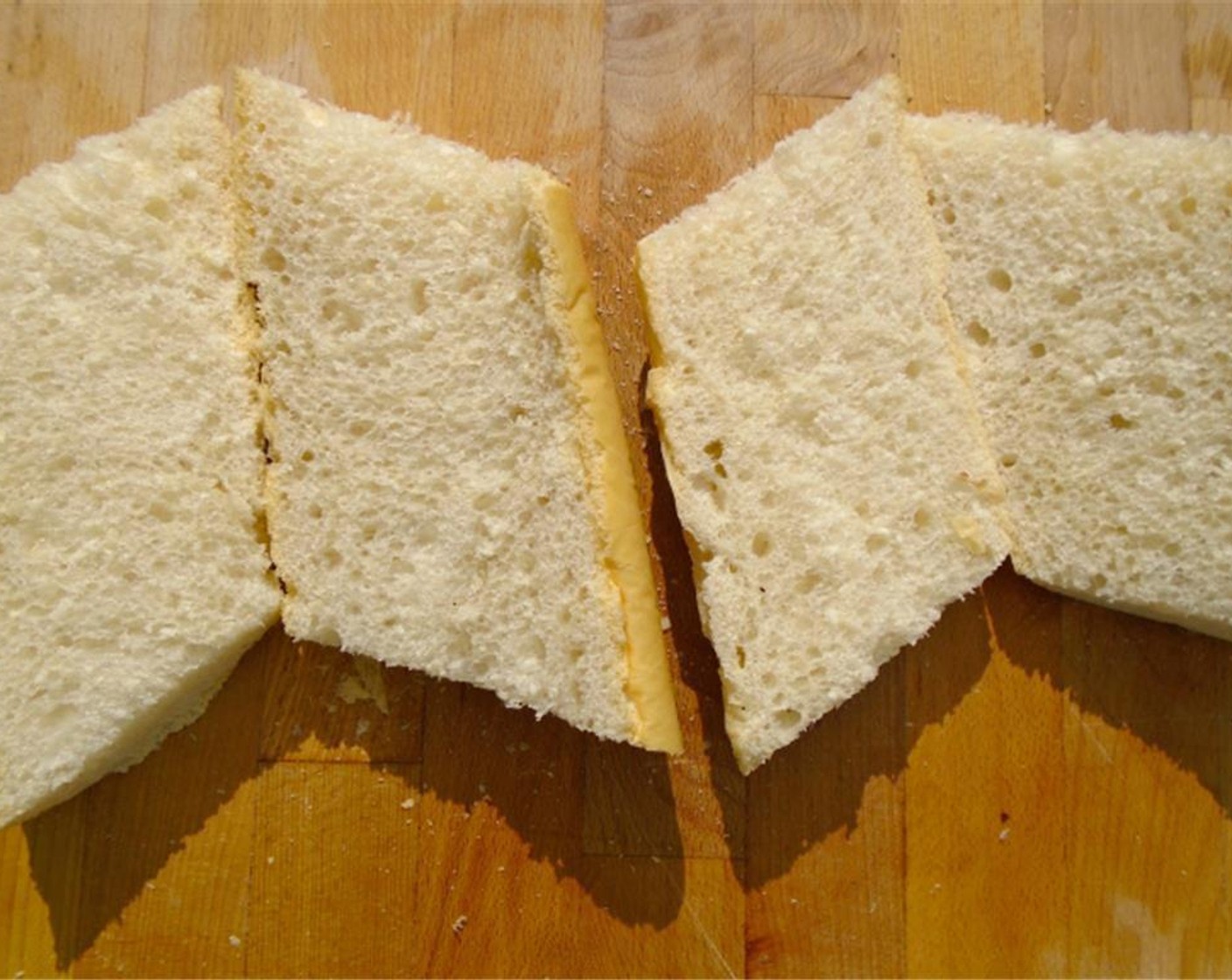 step 5 Set the sliced pork shoulder aside and begin preparing the sandwiches. Slice the Cuban Bread (1).