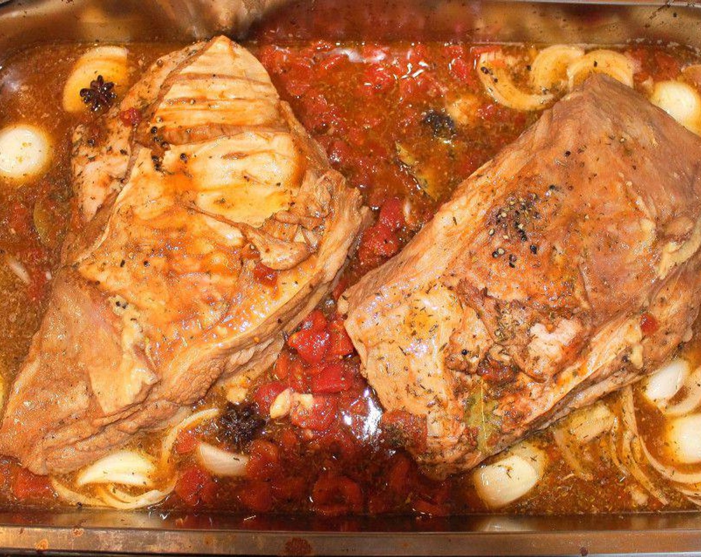 step 3 The next day, discard the brine and transfer veal into a roasting pan, add Chicken Stock (8 cups), Red Wine (4 cups), Tomatoes (5 cups), {@10:}, Soy Sauce (1 cup), Garlic (6 cloves), Dried Oregano (1 Tbsp), Dried Thyme (1 Tbsp), Kosher Salt (1/2 Tbsp), Black Peppercorns (15), and Bay Leaves (4).