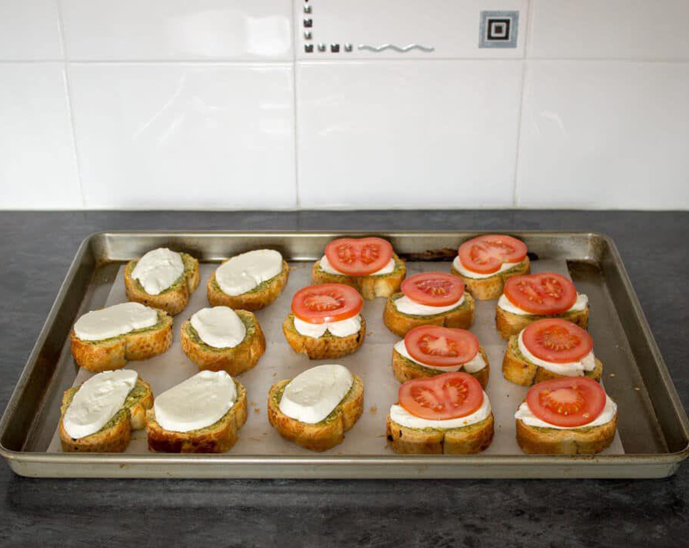 step 5 Lay a slice of mozzarella on each one then top with a slice of tomato.
