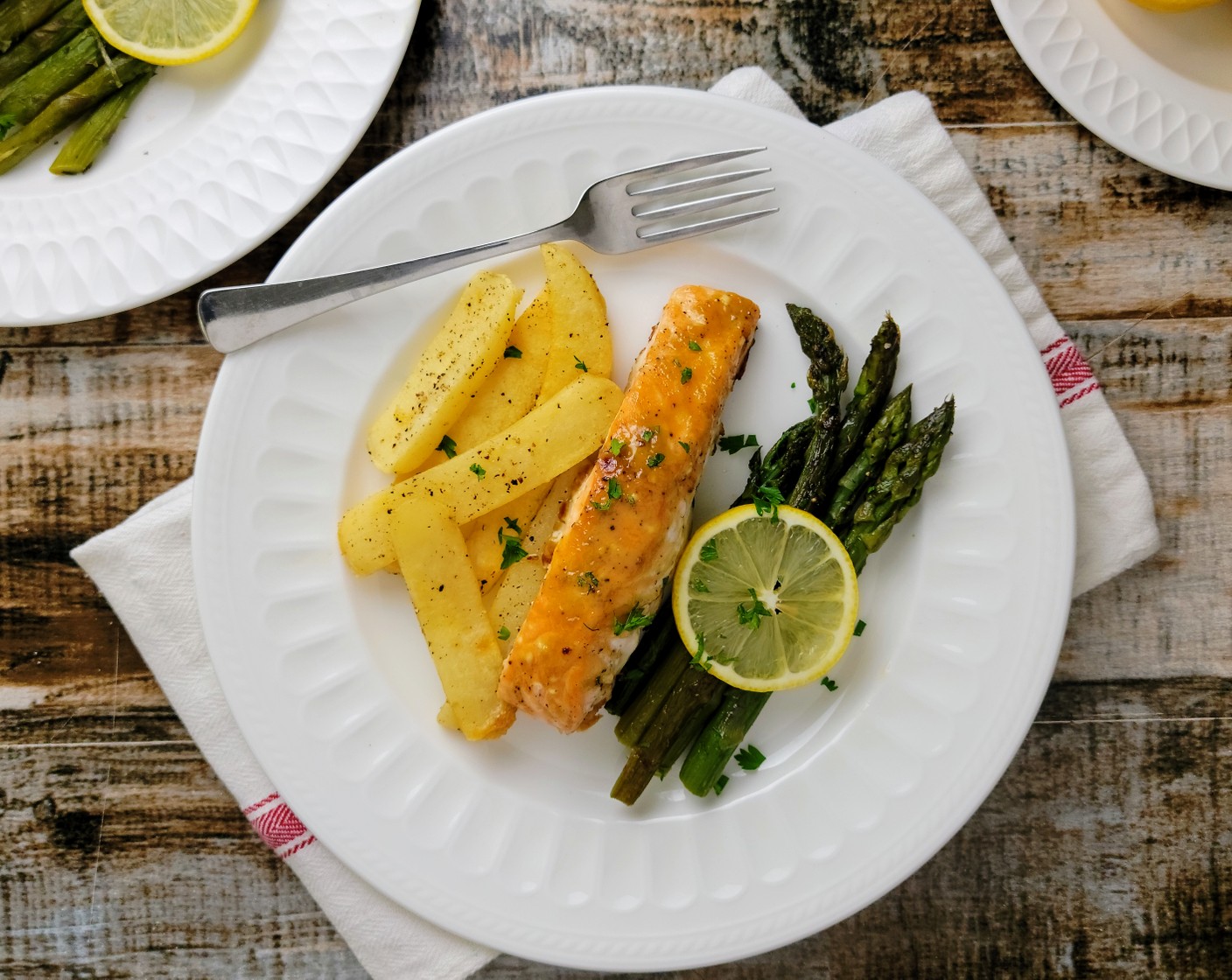 step 8 Remove both pans from the oven and serve immediately, with a squeeze of Lemon (1) over the asparagus.