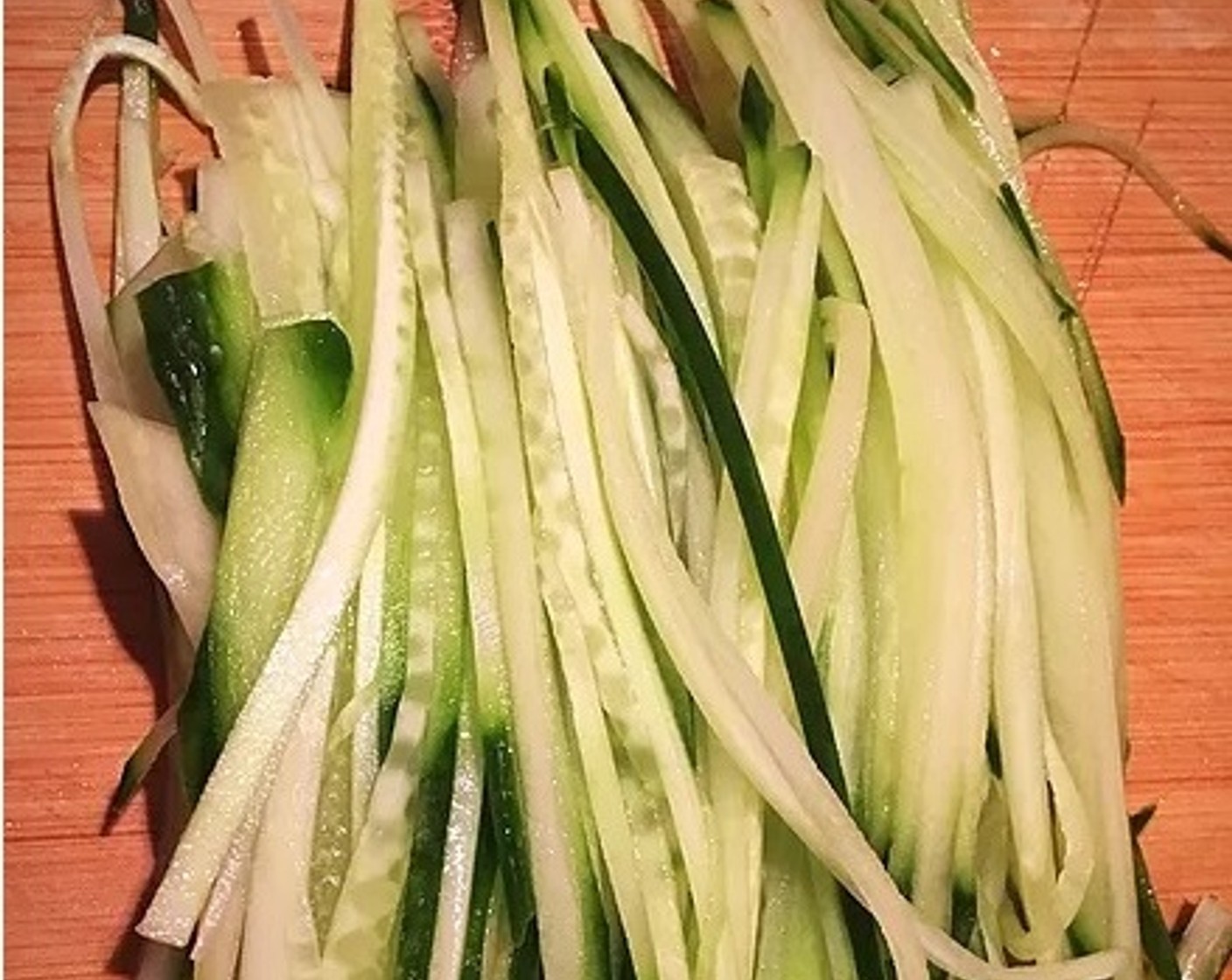 step 9 Slice the Cucumber (1) into long thin strips.  Set aside.