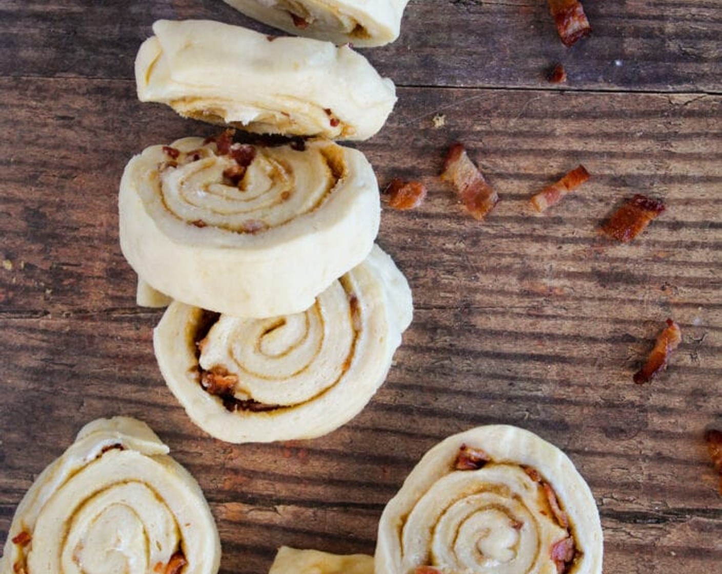 step 9 Starting on the long side of the cinnamon rolls, tightly roll up the dough. Using a serrated knife, cut the roll into 24 equal pieces.