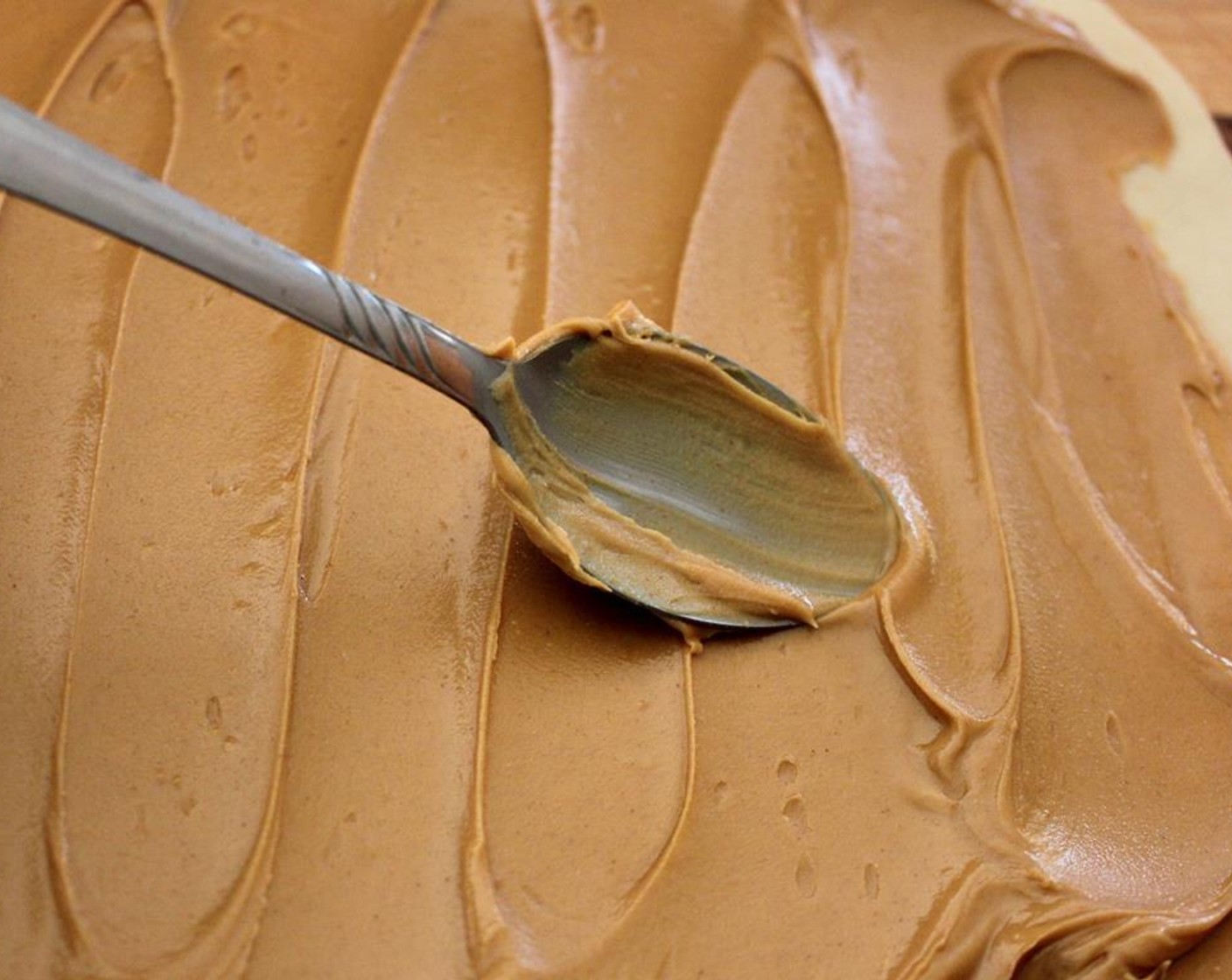 step 2 Unroll the Pie Crust (1 pckg) and smear one of them with an even layer of Creamy Peanut Butter (2 cups).