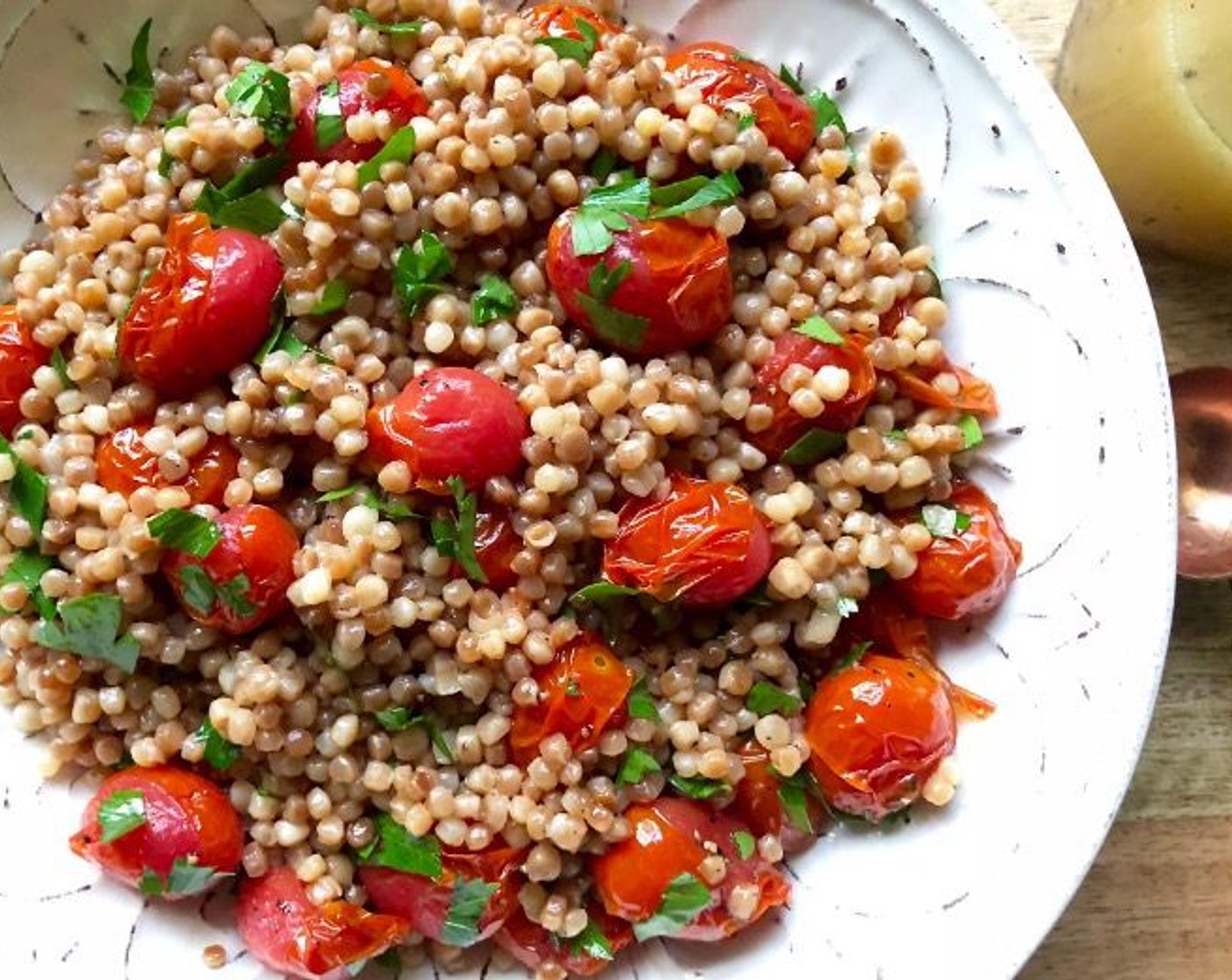 step 8 Transfer couscous to a serving bowl. Add Honey Vinaigrette and toss to coat. Gently stir in roasted tomatoes and Italian Flat-Leaf Parsley (1/3 cup).