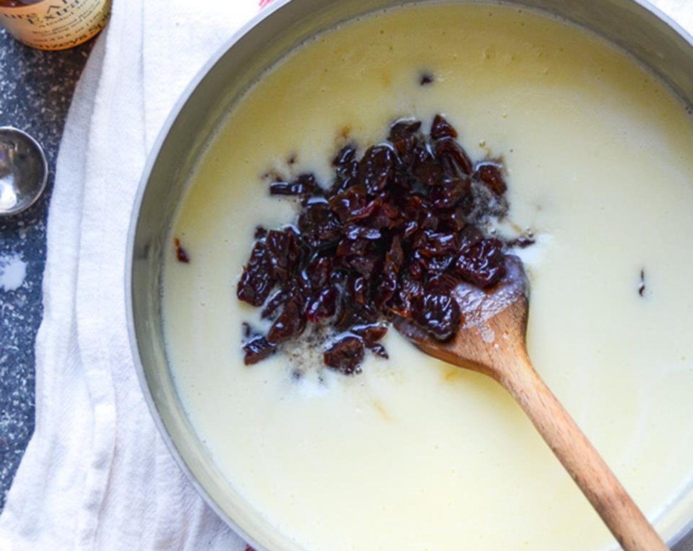 step 7 Pour the mixture through a strainer into a large clean bowl. Stir in the Heavy Cream (1 cup), the cherries mixture, and Almond Extract (1/2 Tbsp).