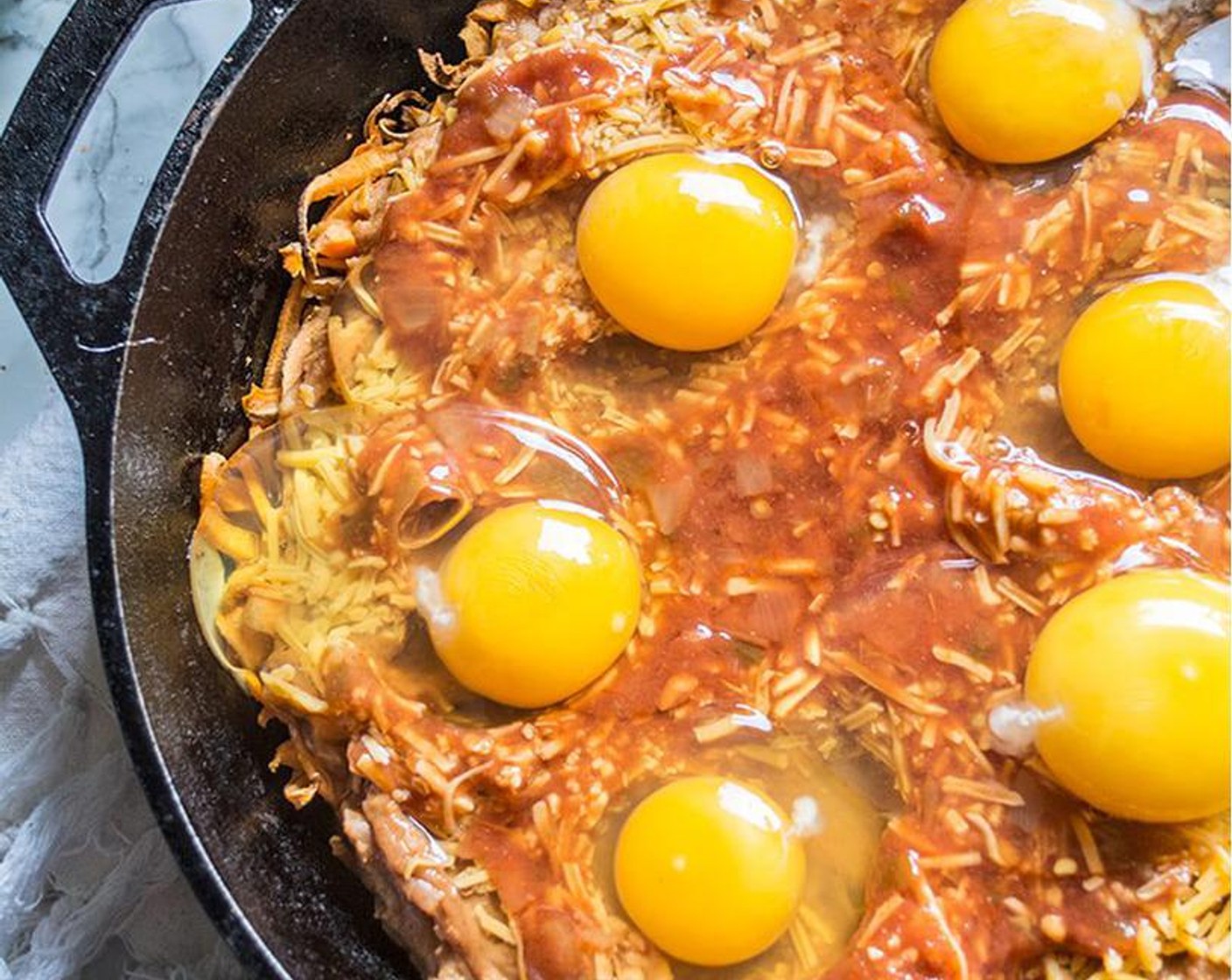 step 5 Remove sweet potatoes from oven, add seasoned refried beans, followed by Shredded Mild Cheddar Cheese (1/4 cup), Salsa (1/4 cup), and Organic Eggs (6). Bake additional 15 minutes, or until egg whites are cooked and yolks are medium.