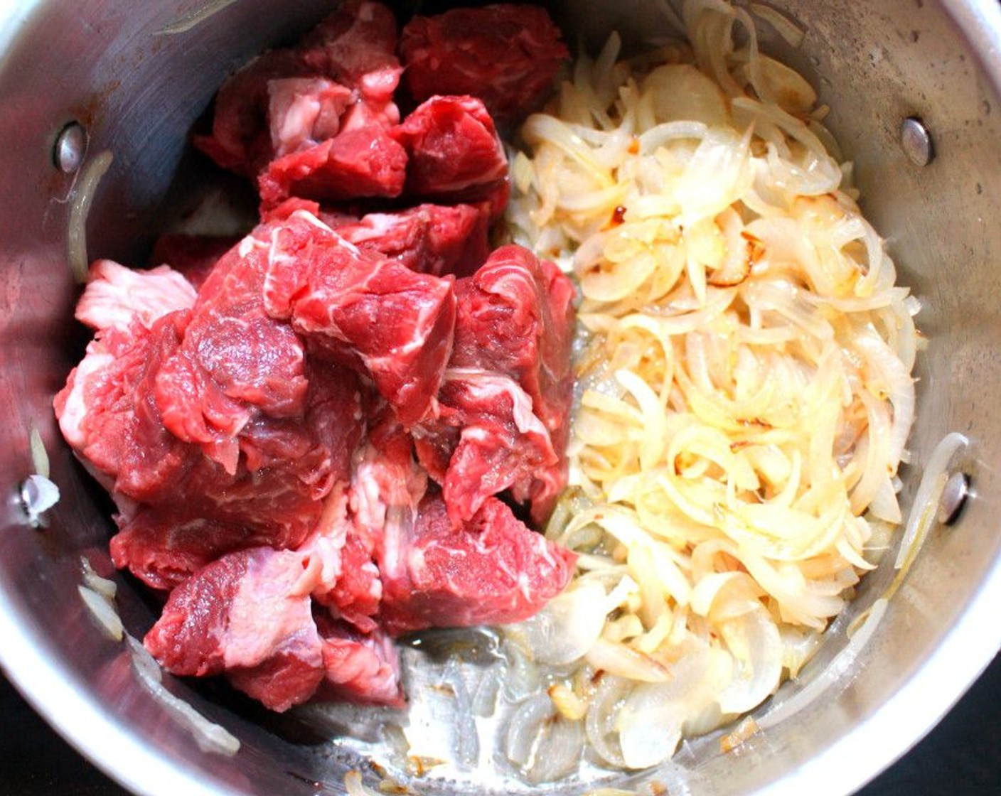 step 4 Add the cubed beef to the onions, then cover and braise until most liquid has evaporated, about 15 minutes.