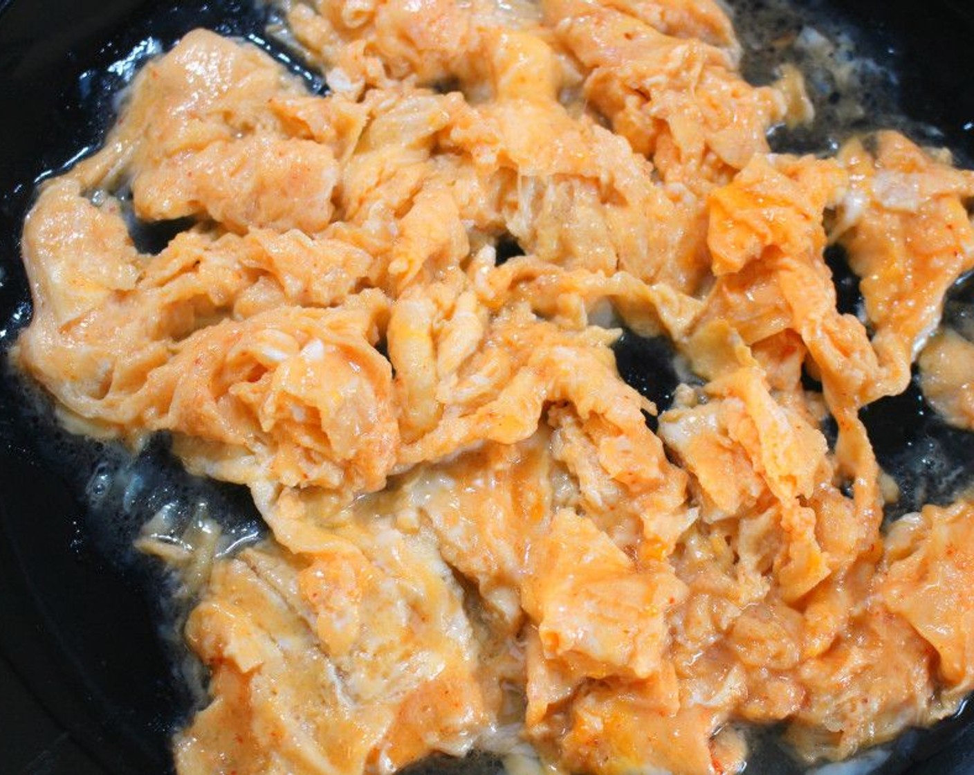 step 2 Take the salmon out of the pan and add more Peanut Oil (1 Tbsp) over medium heat. Once oil is hot, add the Eggland's Best Classic Eggs (3) and stir, then season with Salt (to taste) and Ground Black Pepper (to taste). Cook until still slightly underdone (still moist), then remove from the pan.