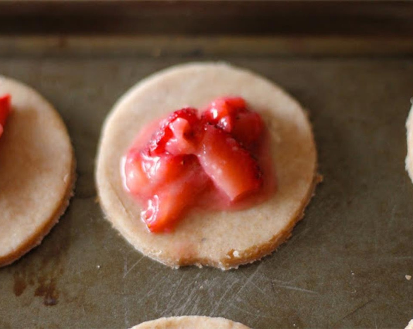 step 10 Add a spoonful of the filling to each circle of dough on your cookie sheet.