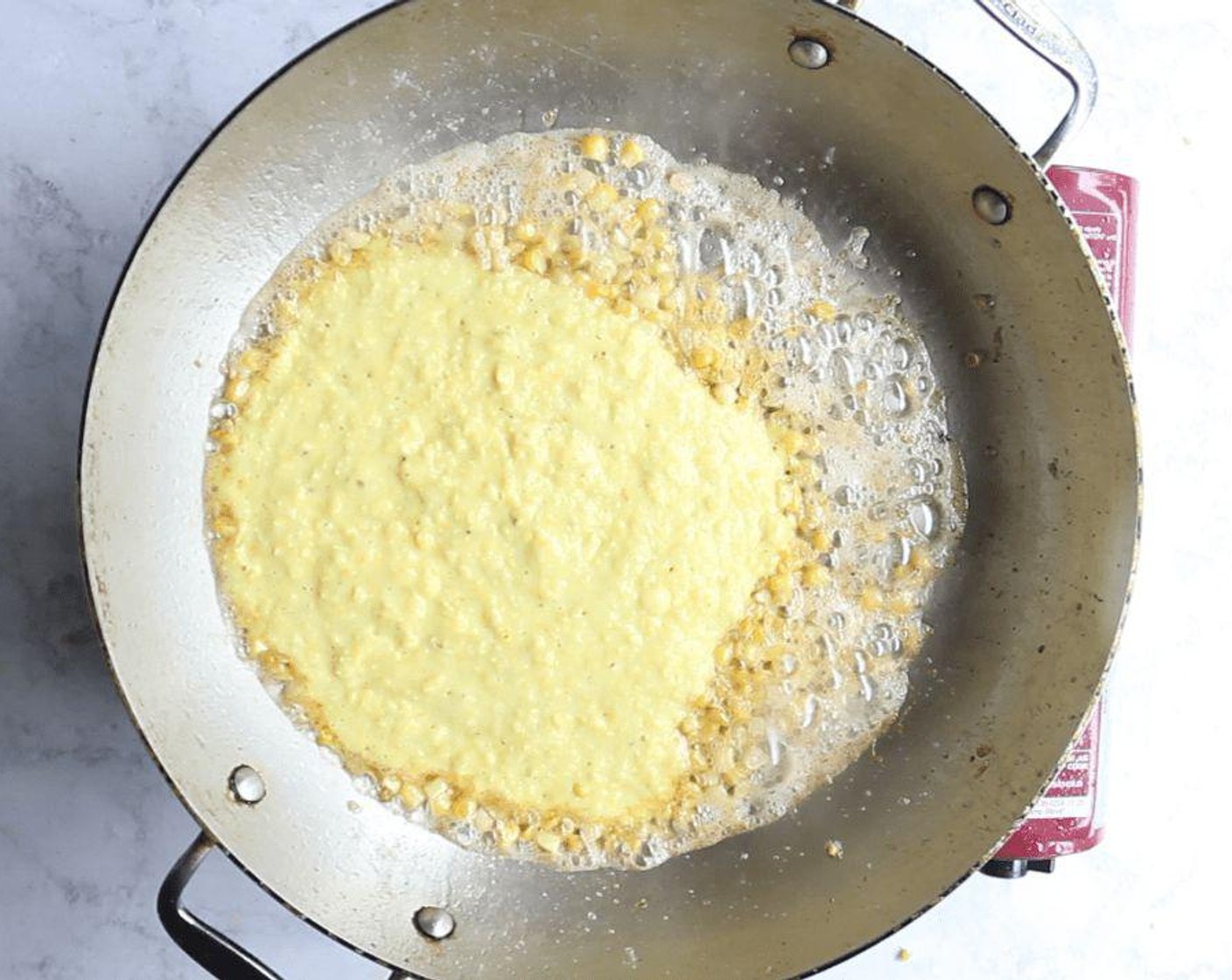 step 5 Heat the same skillet over high heat. Add Unsalted Butter (1/3 cup) and let melt. Add reserved 1/4 cup corn and cook until tender, 1 to 2 minutes. Add the corn purée and cook for 30 seconds to heat and combine the flavors.