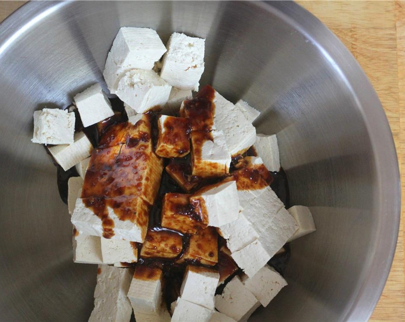 step 4 When the tofu is ready, cube up the slabs and add to the marinate. Toss the cubes gently by hand to coat. Let sit for 10 minutes.