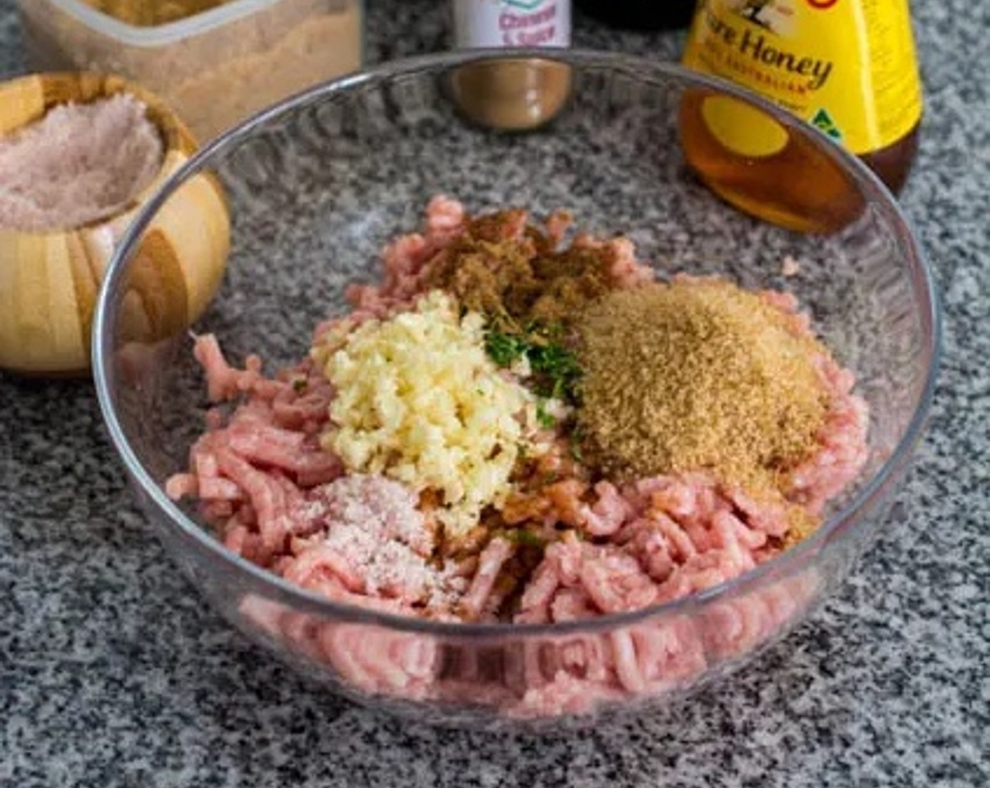 step 1 In a large bowl add Ground Pork (1 lb), Honey (1 Tbsp), Light Soy Sauce (1 1/2 Tbsp), Shaoxing Cooking Wine (1 tsp), Brown Sugar (2 Tbsp), Corn Starch (1 1/2 Tbsp), Chinese Five Spice Powder (1 tsp), Salt (1/2 tsp), Garlic (3 cloves), and Fresh Cilantro Leaves (5). Mix well and allow to marinate for 15 minutes.
