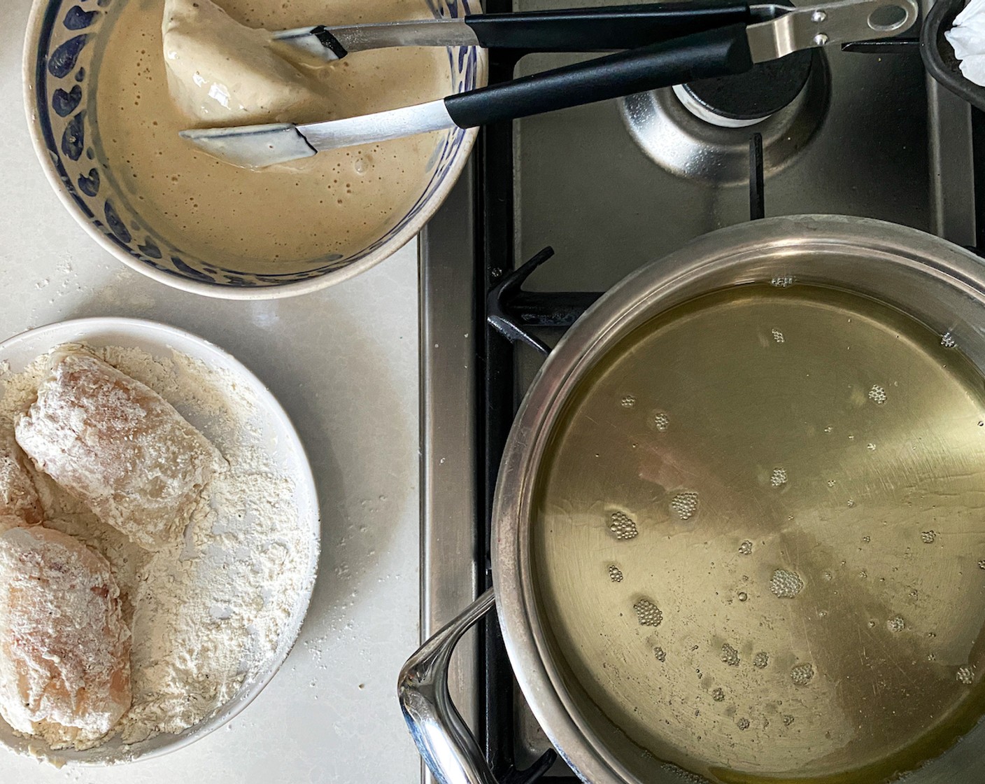 step 6 Once the oil is moderately hot, coat the Frozen Cod Fillets (4) well in seasoned flour, followed by a generous coating of batter. Allow excess to drip off.