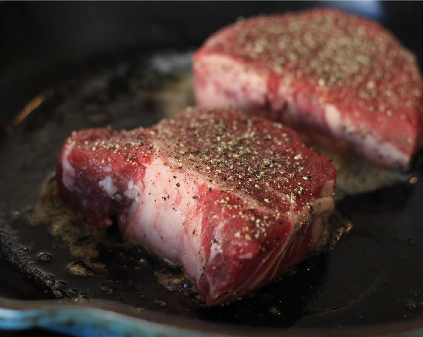 step 2 Season the 2 Angus Beef Filet Mignon (12 oz) generously with fresh cracked pepper and salt. Sear in hot pan for 3 minutes on each side for rare.