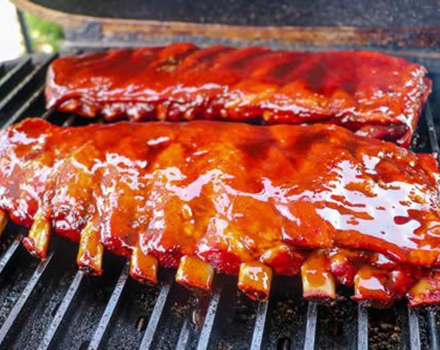 step 8 Combine Barbecue Sauce (1 cup) and brush over the back side of each slab. Place each directly on the cooking grate bone side down and brush sauce over the top (meat) side.