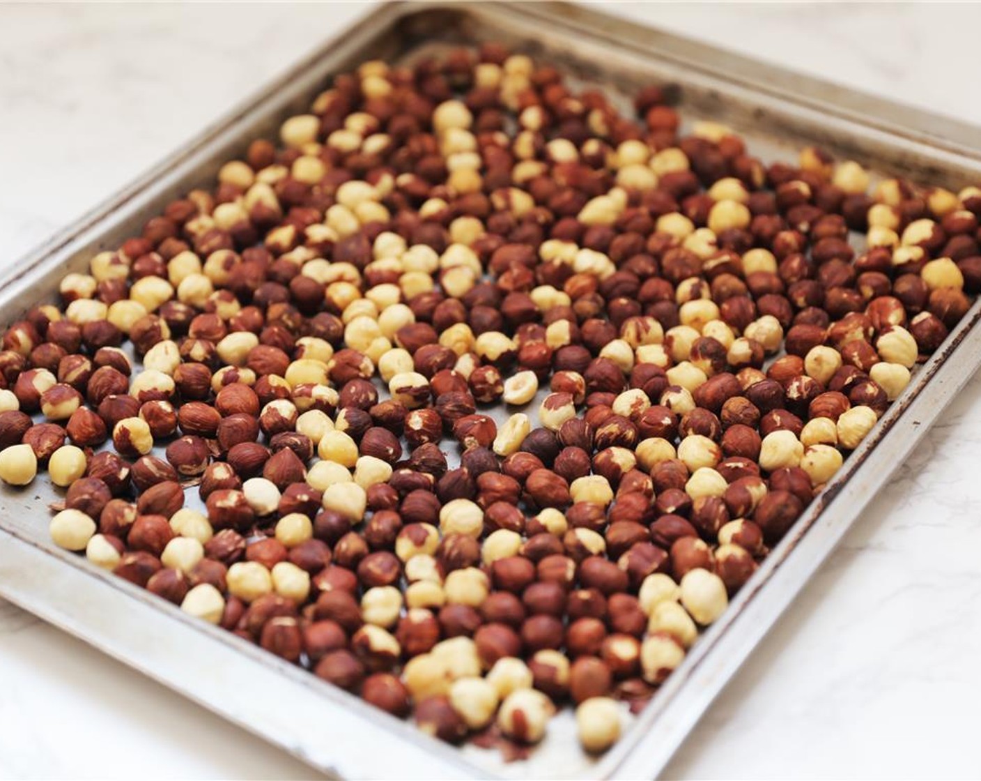 step 2 Place Unsalted Hazelnuts (3 3/4 cups) in the oven for about 10 minutes.
