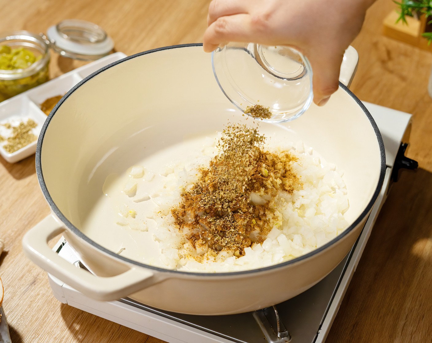 step 1 In a dutch oven or heavy-bottomed pot, heat up the Olive Oil (1 Tbsp) over medium-high heat. Once hot add the Yellow Onion (1), Garlic (4 cloves), Ground Cumin (1/2 Tbsp), Dried Oregano (1 tsp), and Cayenne Pepper (1/2 tsp). Cook for 3 minutes until the onions begin to soften.