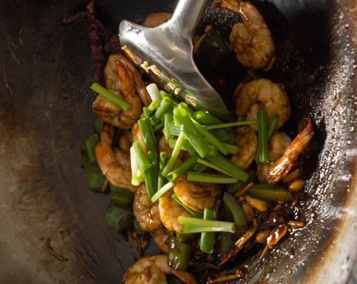 step 5 Add the Dry Roasted Peanuts (1/4 cup) and stir in the sauce. When the sauce thickens, turn off the heat and toss in the Scallion (1 stalk).