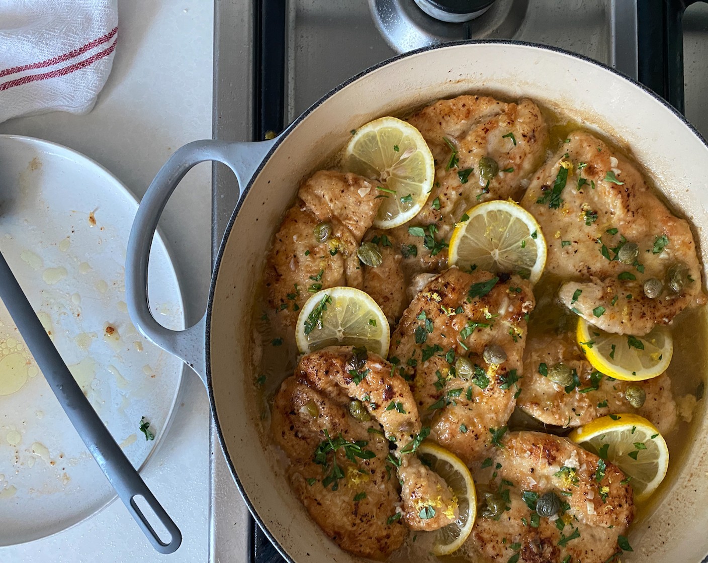 step 7 Submerge the browned chicken into the sauce, top with lemon slices, and sprinkle with parsley and remaining capers. Simmer over moderate heat, uncovered, for 20- 25 minutes. Spoon sauce over the chicken every so often.