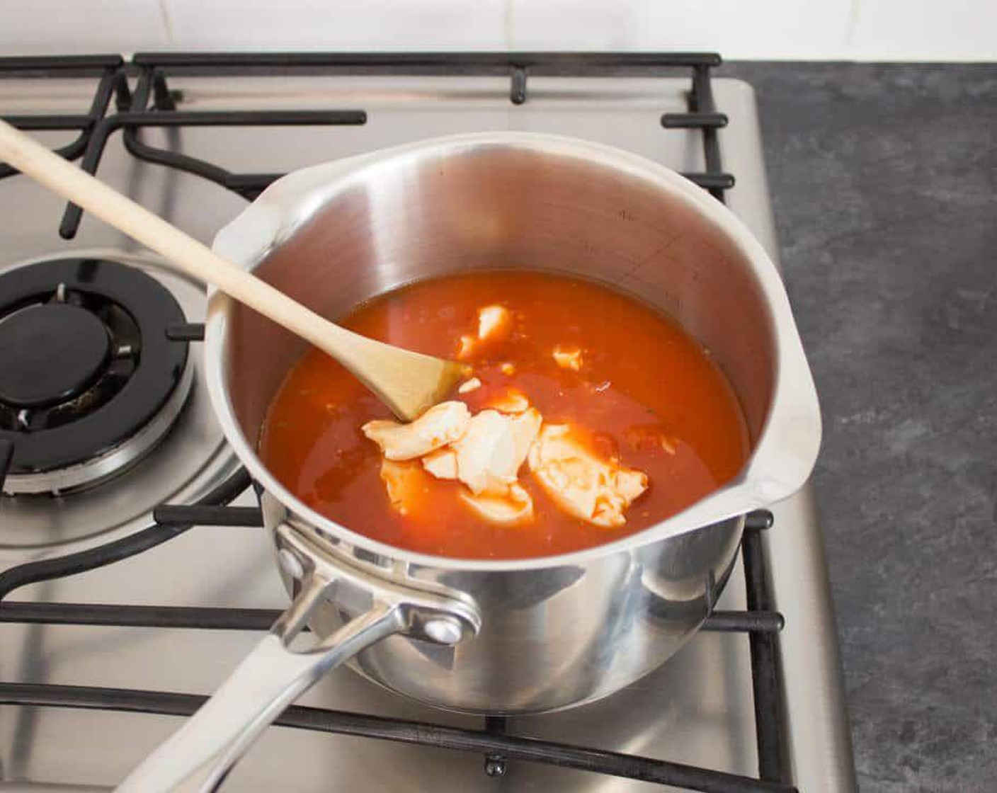 step 1 Place Fusilli Pasta (1 pckg), Tomato and Garlic Sauce (1 jar), Cream Cheese (1/3 cup), Water (1 2/3 cups), and Salt (to taste) into a large saucepan over high heat.