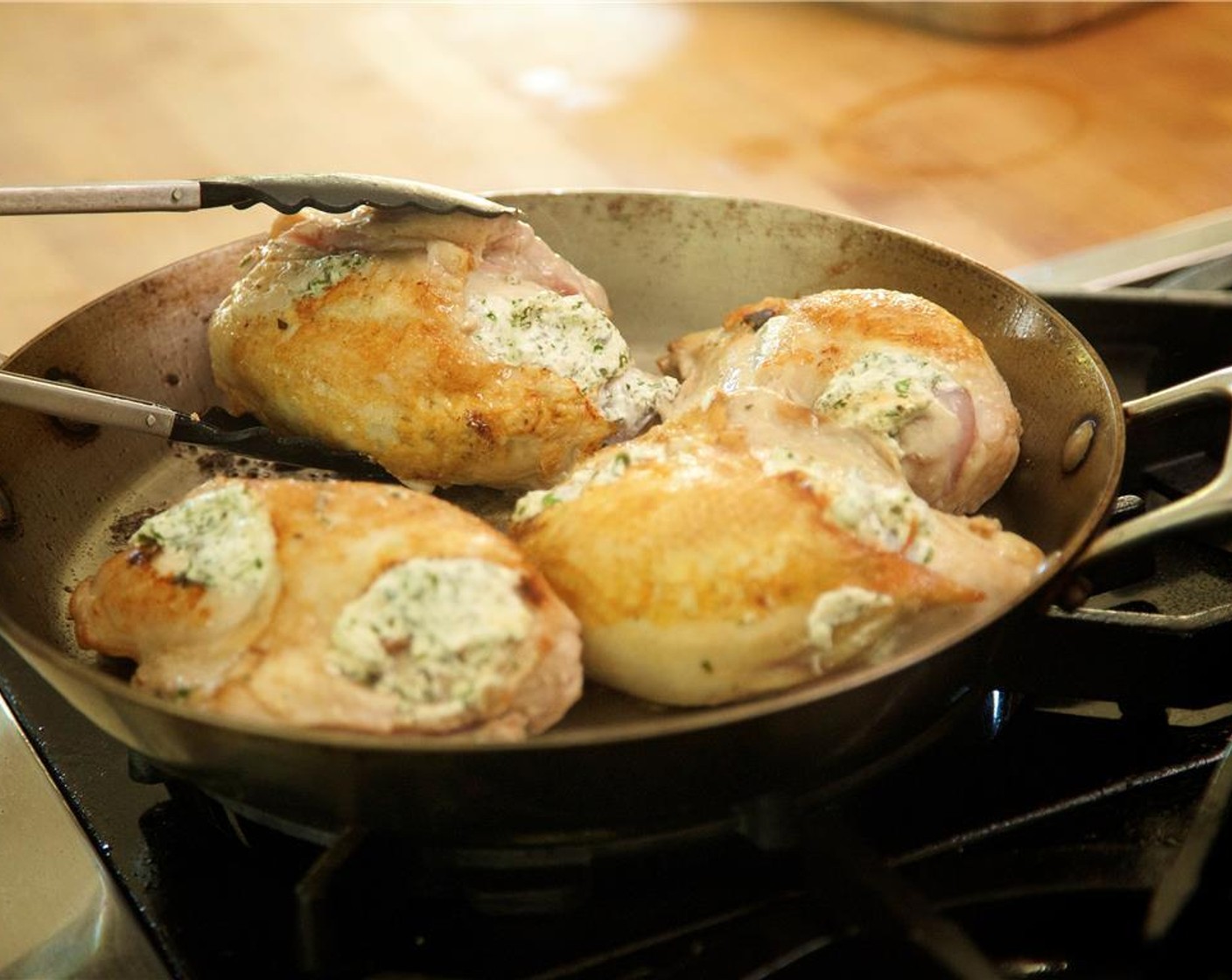 step 17 Using tongs, gently turn the breasts over and continue cooking for 3 minutes.