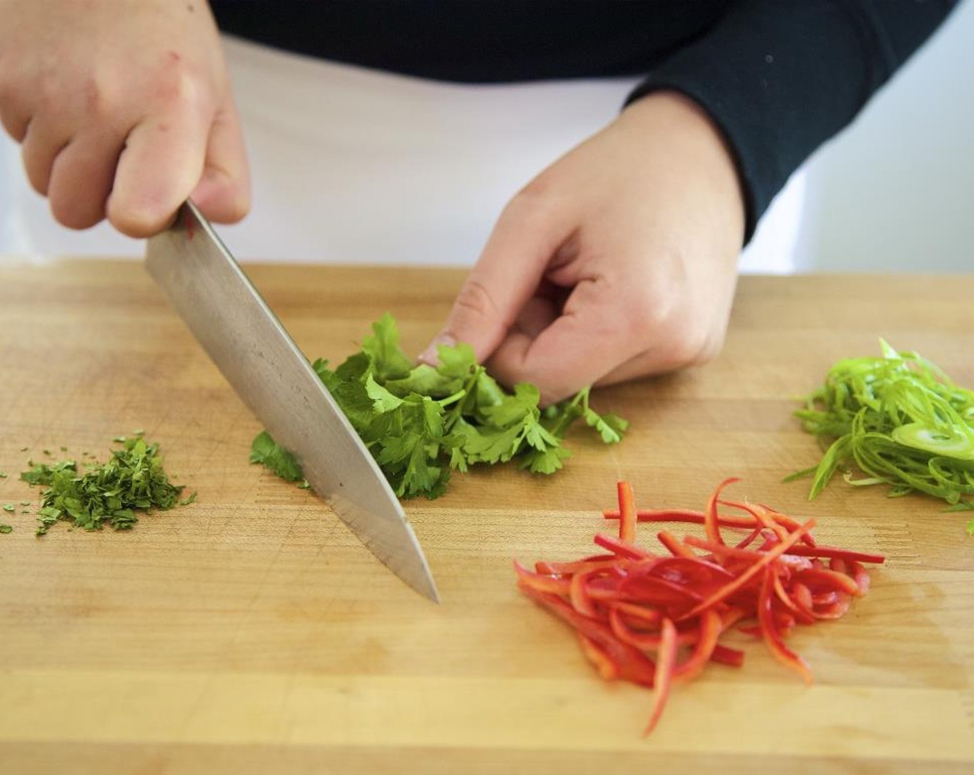 step 7 Remove the Fresh Basil (1/2 cup) and Fresh Cilantro (1/2 cup) leaves from their stems and discard stems. Chop the herbs and add to the medium bowl with the green onion mixture; hold.