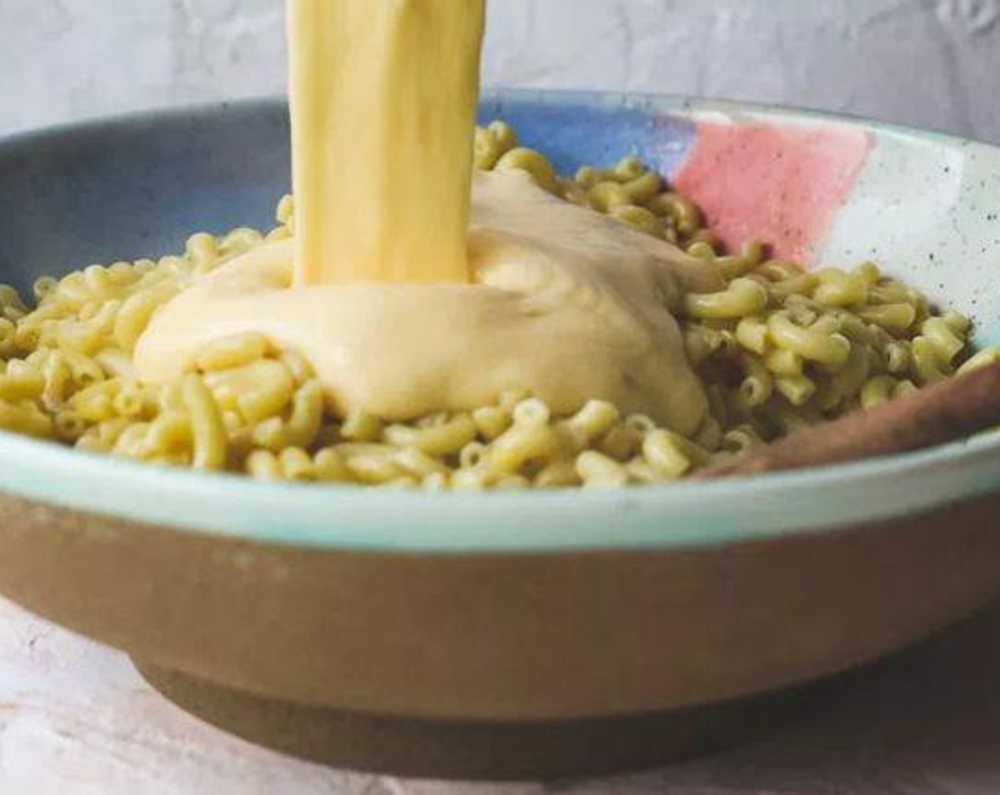 step 5 Mix the cooked pasta and cheese sauce together in a large bowl.