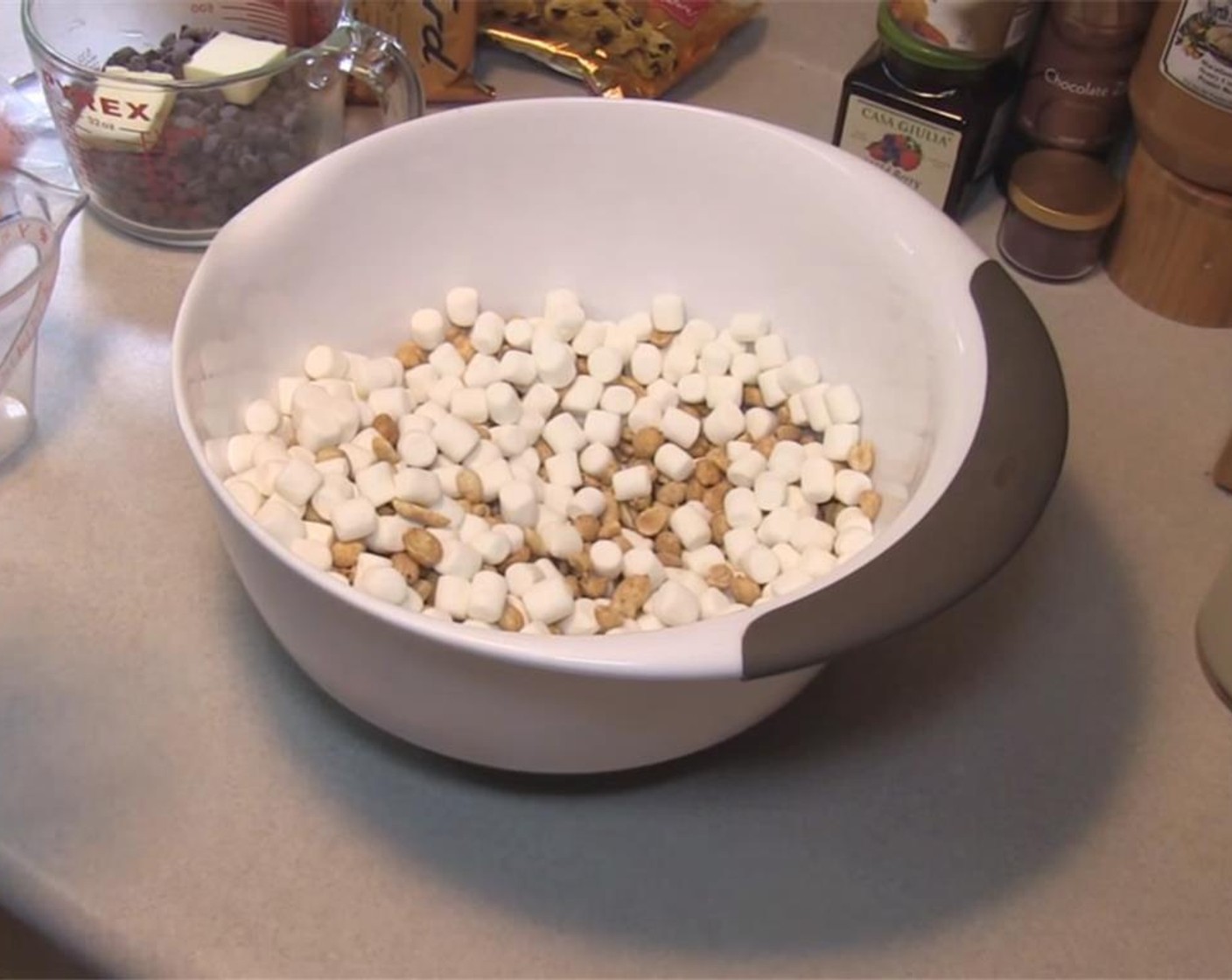 step 1 Line a 9x9-inch pan with parchment paper. Mix together the Dry Roasted Peanuts (2 cups) and Mini Marshmallows (7 cups) in a large bowl and set aside.