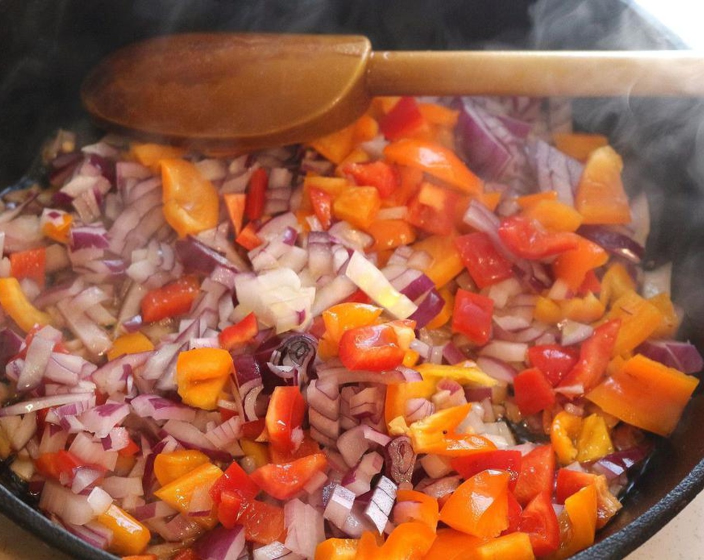 step 1 Sautee Red Chili Pepper (1), Yellow Bell Pepper (1), and Red Onion (1) in Extra-Virgin Olive Oil (2 Tbsp).