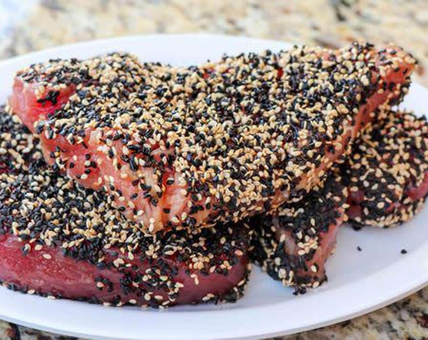 step 3 Coat the Fresh Tuna Steak (4) with the sauce mixture, then press into the sesame seeds to coat.