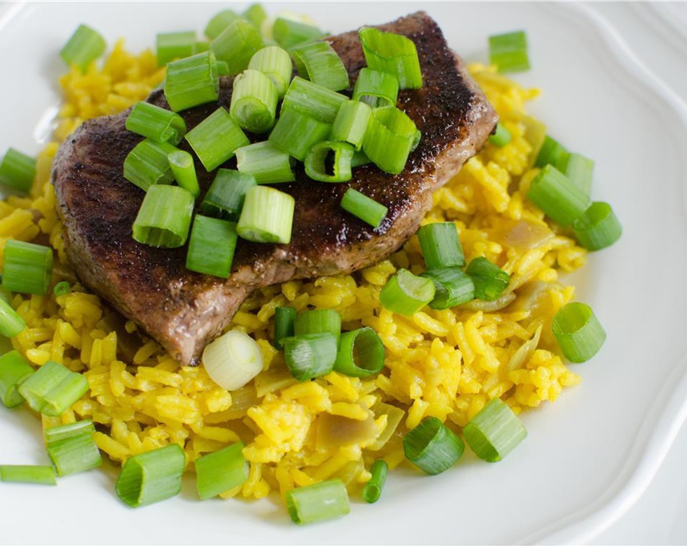 step 9 Fluff rice with fork. Plate steak with rice, then garnish with scallions. Serve with Sugar Snap Peas (2 cups) on the side.