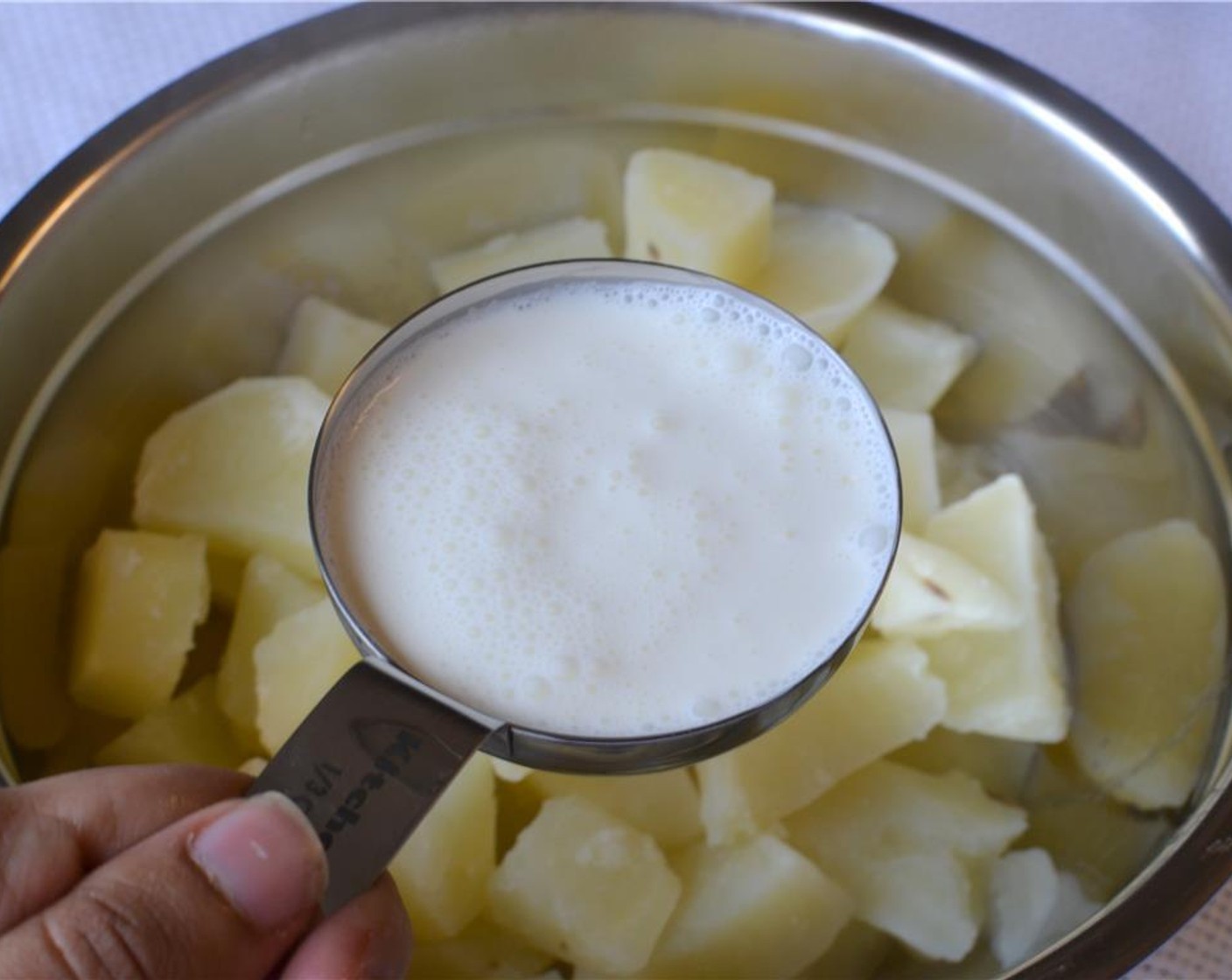 step 9 Add the Butter (3 Tbsp), Heavy Cream (2/3 cup) to them while still hot and mash them with a potato masher. Season it with Salt (to taste) and Ground Black Pepper (to taste).