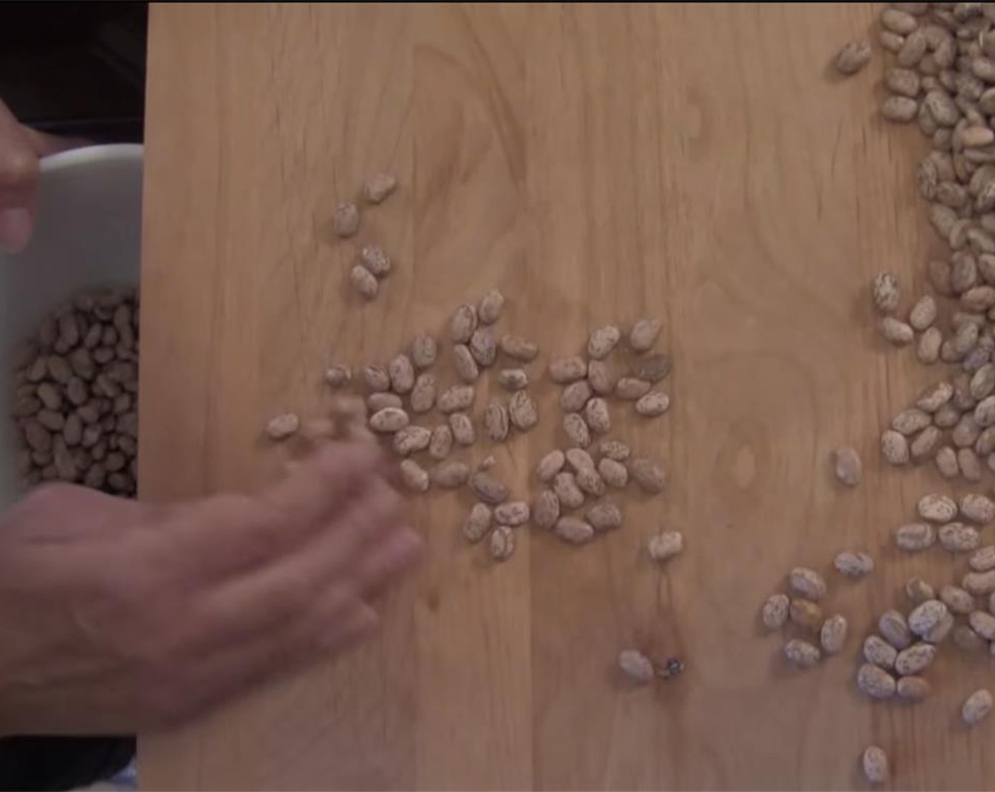 step 1 Pour Dry Pinto Beans (2 cups) out onto a flat surface, and sort through, removing rocks and irregular beans.