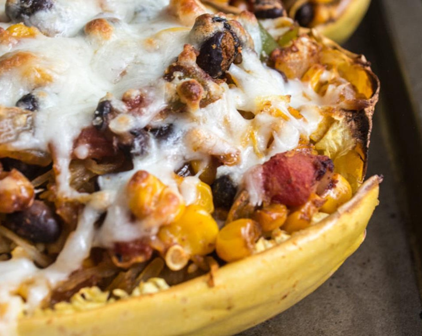 step 7 Remove spaghetti squash from oven and use a fork to shred the cooked flesh from each half, then spoon the cooked flesh into the bean and veggie mixture, stir until well mixed. Scoop filling back into each skin/half and top each with Shredded Mozzarella Cheese (1/2 cup).