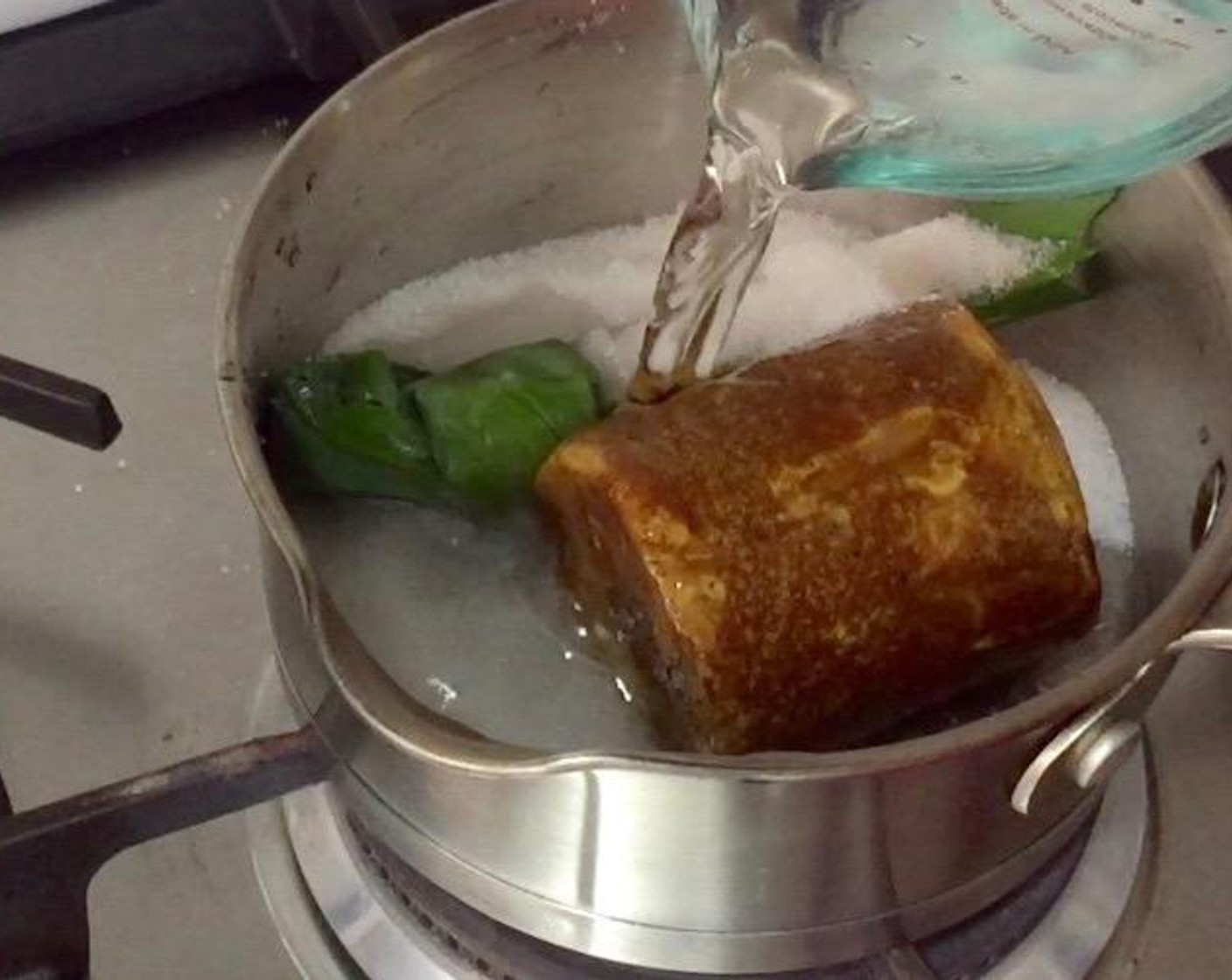 step 5 Put Granulated Sugar (1 Tbsp), Palm Sugar (2 cups), knotted pandan leaves, and Water (3/4 cup) in a pot.