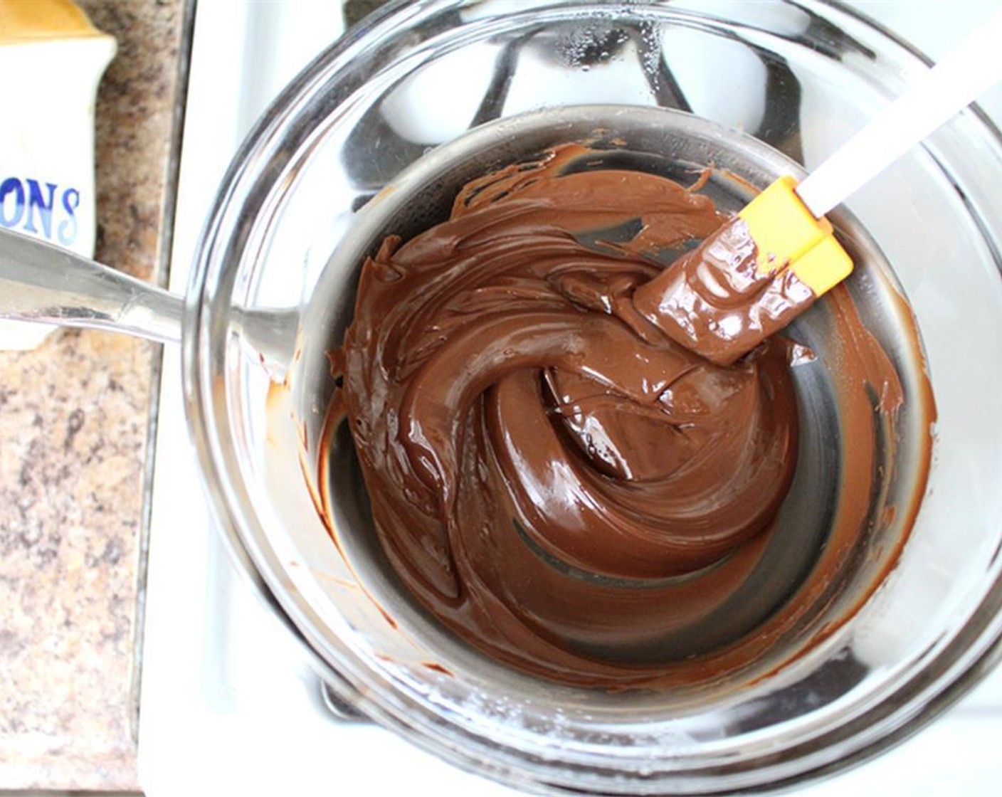 step 6 Add 46% Cacao Chocolate (1 cup) the bowl and stir occasionally until chocolate is melted. Remove from heat.