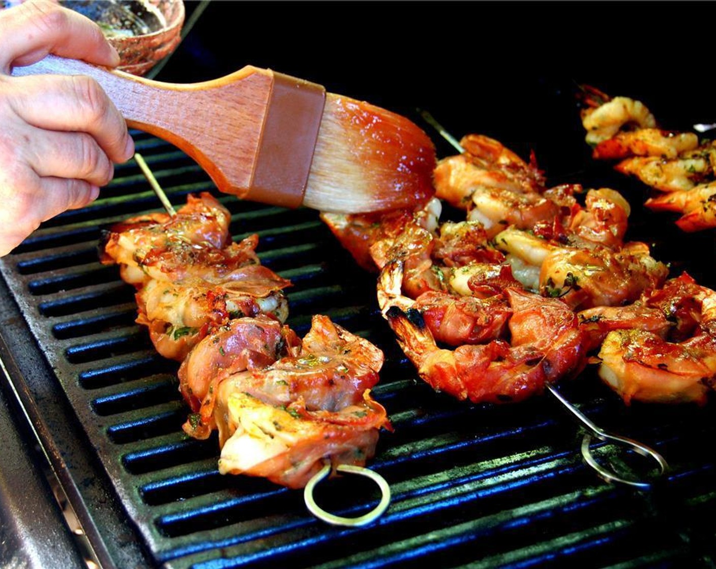 step 6 Grill shrimp over moderately high heat. Baste shrimp several times with the grape spread mixture. Cook shrimp until just cooked through, about 2 minutes on each