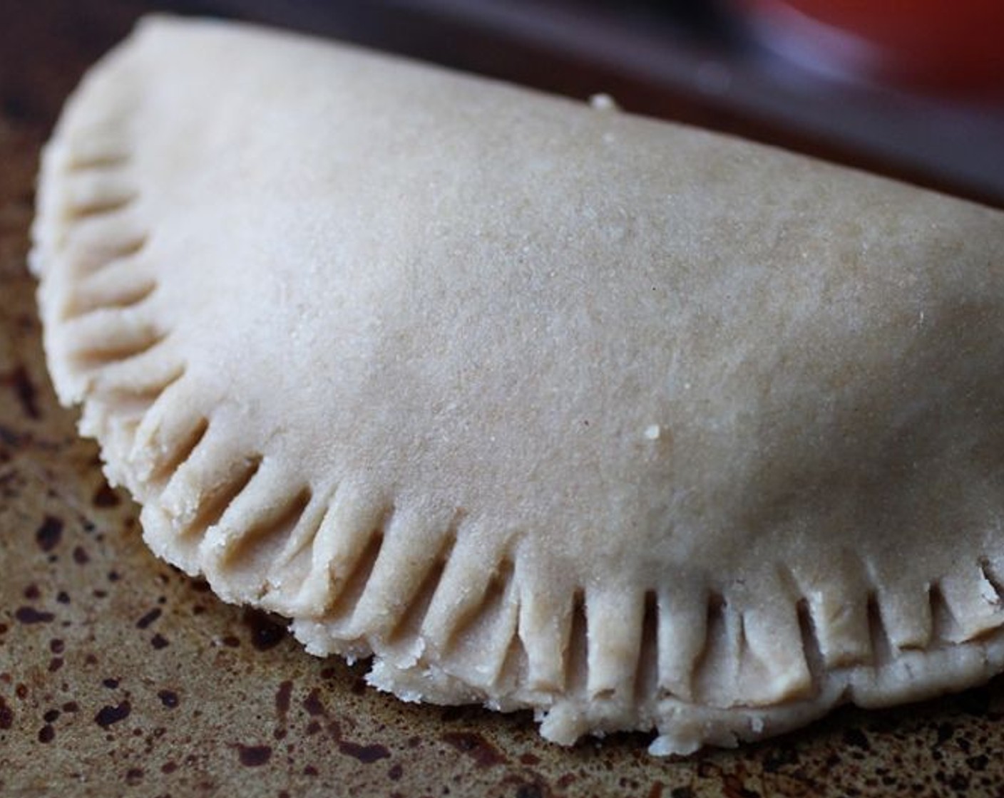 step 8 Carefully fold over one side of the dough on top of the other, and use a fork to seal edges.