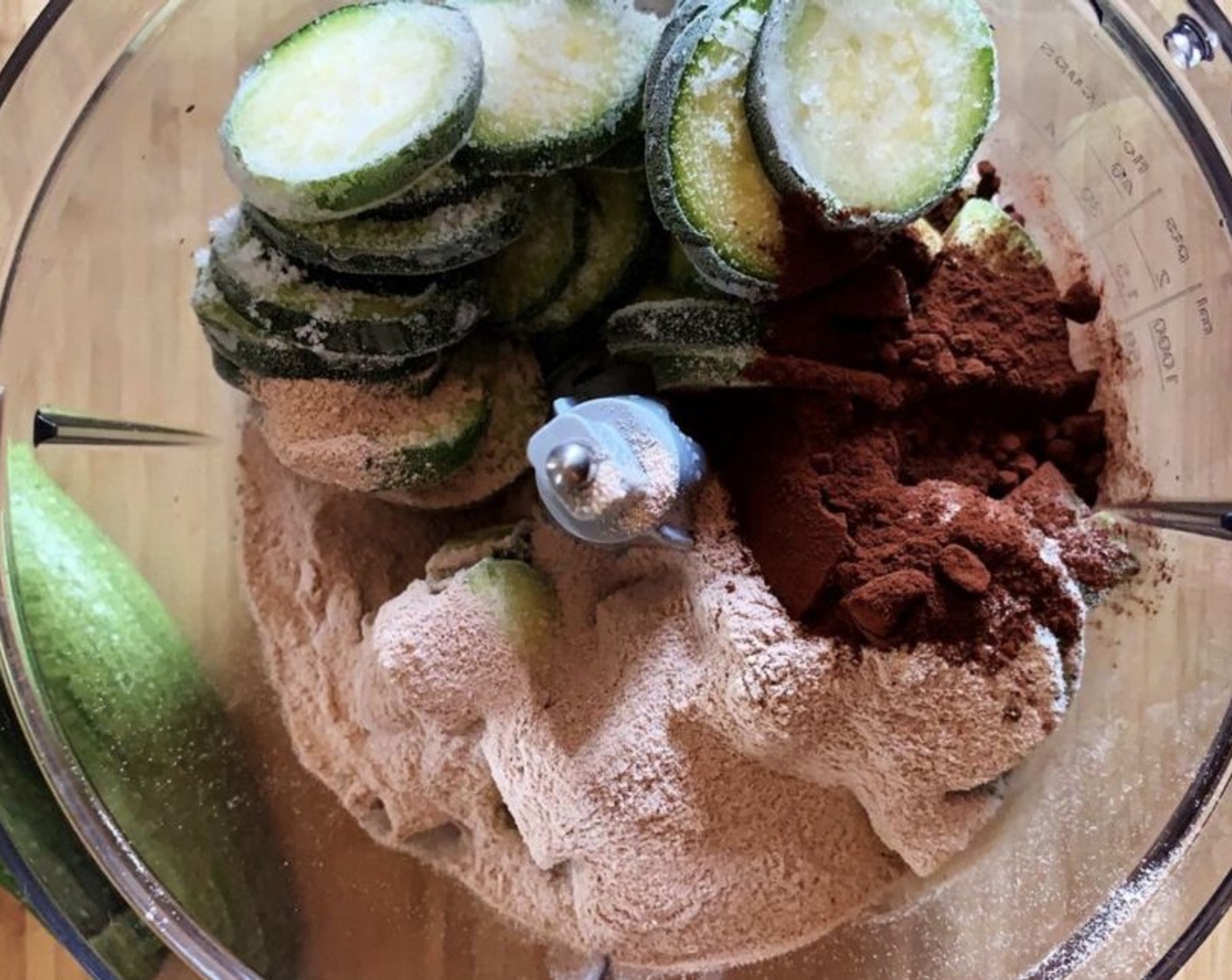 step 1 In a food processor, place the Zucchini (2), Dark Cocoa Powder (2 Tbsp), and Chocolate Protein Powder (1/3 cup).