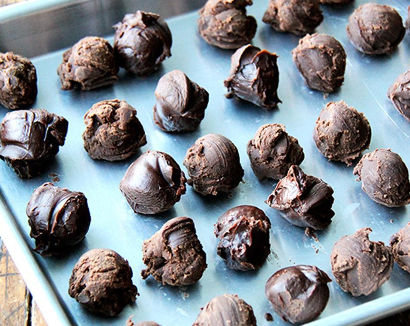step 4 Drag a melon baller across firm chocolate mixture to shape the truffles. Drop truffles onto clean baking sheet. Refrigerate truffles for 15 minutes once formed. As you shape, if the chocolate gets too soft, stick the pan back in the fridge for a bit. If it seems too hard, let it sit at room temperature until it is manageable.