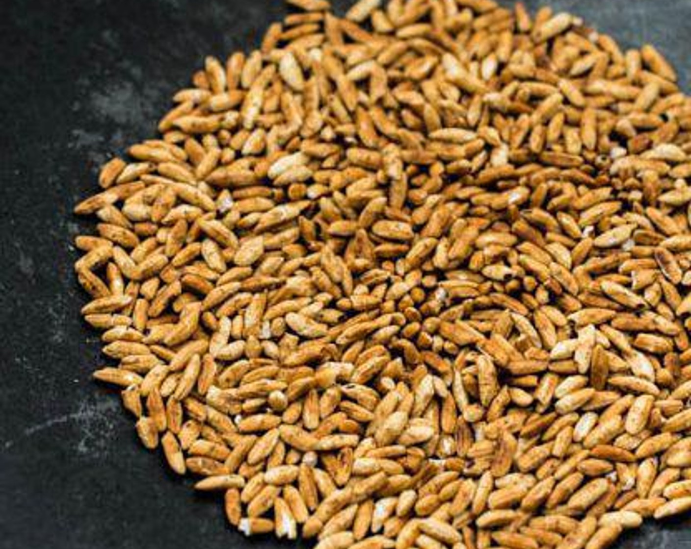 step 1 Put the Glutinous Rice (1 tsp) in a wok over very low heat. Use your wok spatula to stir it frequently until it becomes a deep golden brown color.