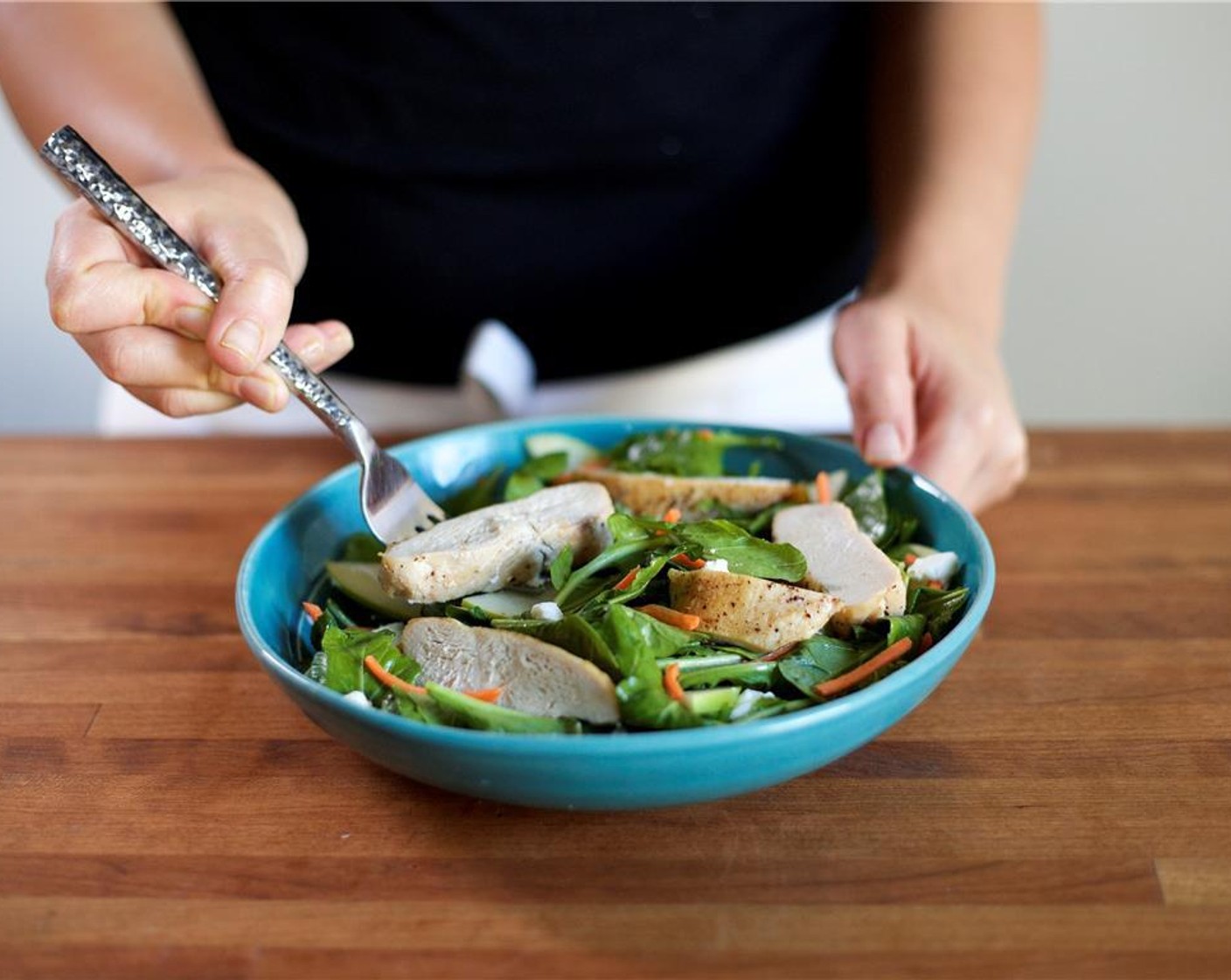 step 8 In the center of two bowl, gently stack the salad. Top with the sliced chicken breast.