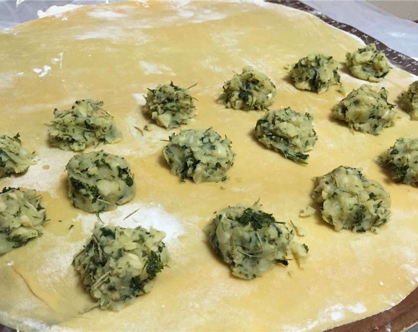 step 3 Roll out Egg Pasta Dough (1.1 lb) until it's thin -- nearly translucent. Spoon out small or large balls of filling onto half, leaving spaces between to separate the ravioli. Brush the spaces between with the beaten Egg (1).