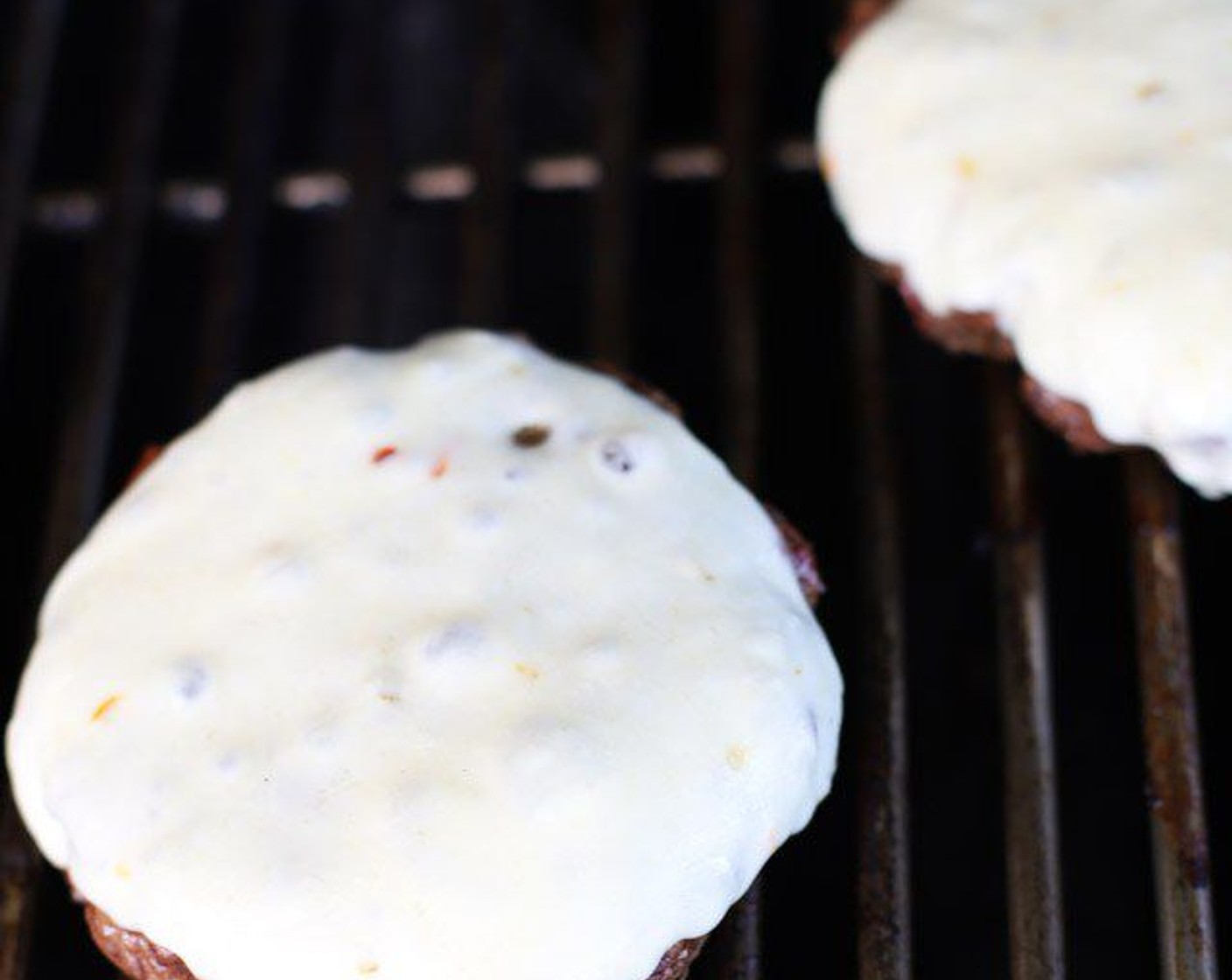 step 7 When the burgers are just about done to your liking, add a slice of Pepper Jack Cheese (4 slices) to each patty. Close the lid on your grill and grill for another 1-2 minutes to melt the cheese slightly.