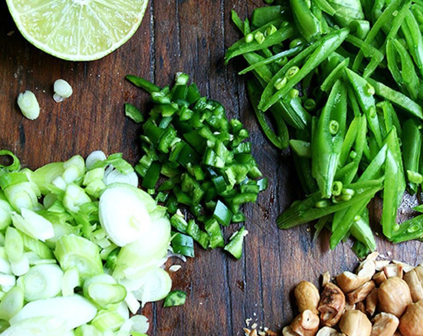 step 2 Prepare the remaining ingredients: Slice the Sugar Snap Peas (1 cup) on a bias and set aside. Roughly chop the Cashew Nuts (1/2 cup). Slice the Scallion (1 bunch) thinly. Remove the seeds from the Serrano Chilis (2), then finely dice.