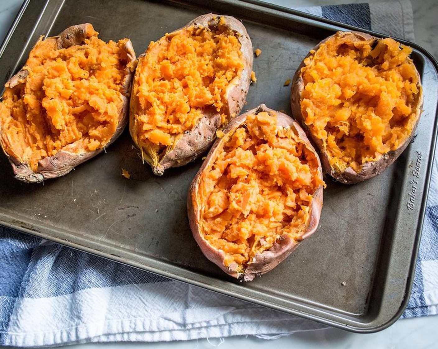 step 7 Once sweet potatoes are cooked through, cut the skin off the top of each then use a fork to break apart and mash the cooked flesh.