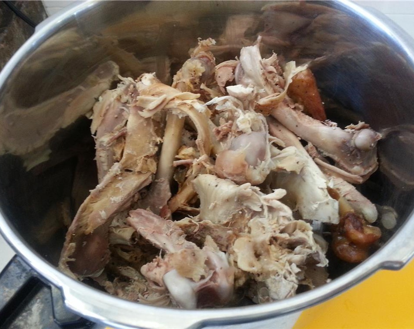 step 6 Cute up leftover Turkey (1) and place the carcass inside your pressure cooker.
