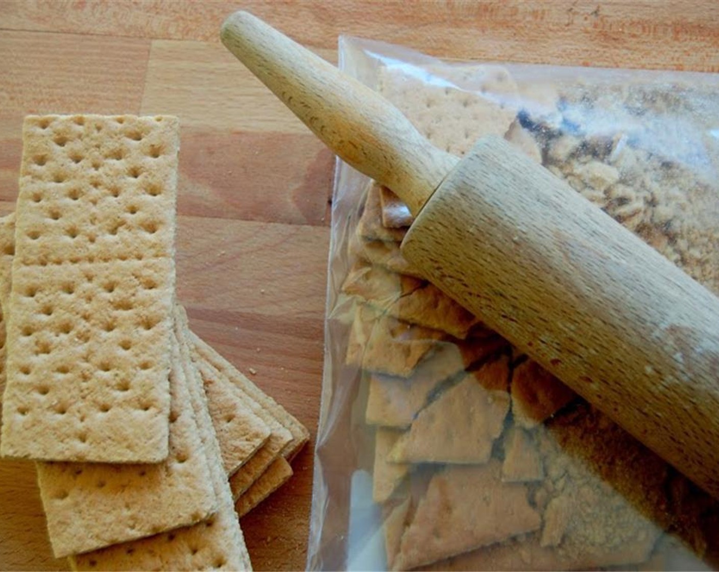 step 1 Finely grind the Graham Crackers (1 pckg) in a food processor or simply crush them with a rolling pin with a plastic bag.